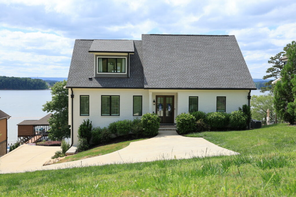 Lakefront home exterior before real estate photo editing services.