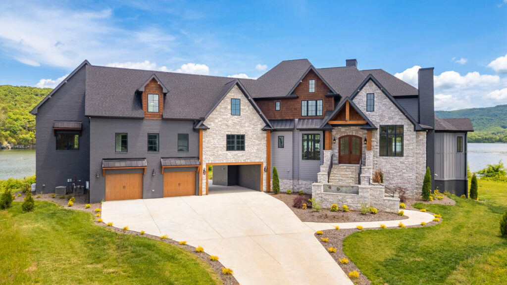Luxury lakefront home enhanced with real estate photo editing services.