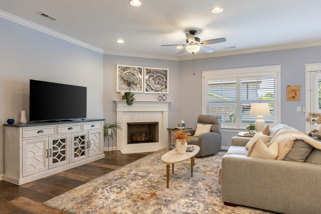 Living room with fireplace enhanced with real estate photo editing services.