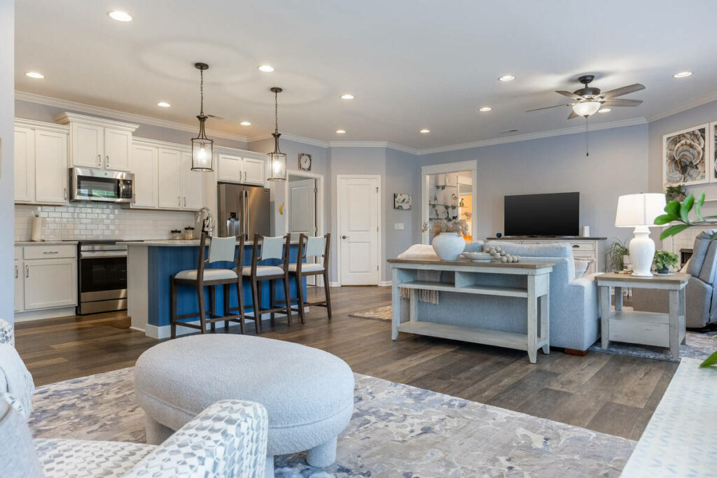 Open kitchen and living area enhanced with real estate photo editing services.