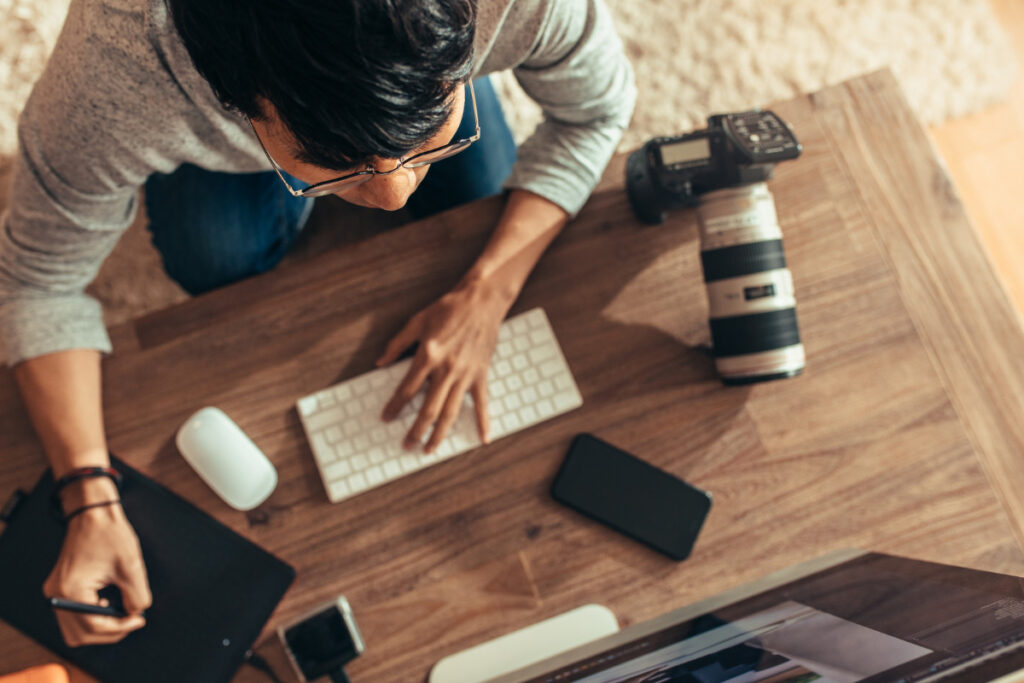 Photographer working at an AI photo editing workstation