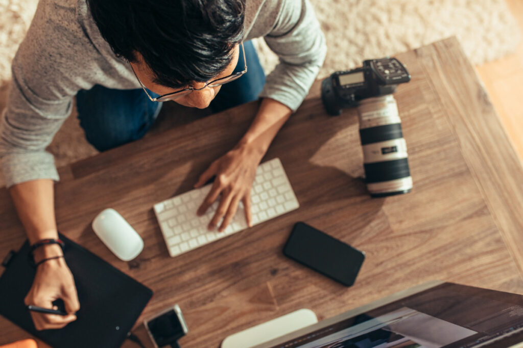 Photographer managing a photo editing workflow at a workstation