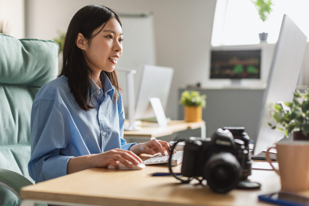 Real estate photographer working at a computer with Imagen AI real estate editing workflow