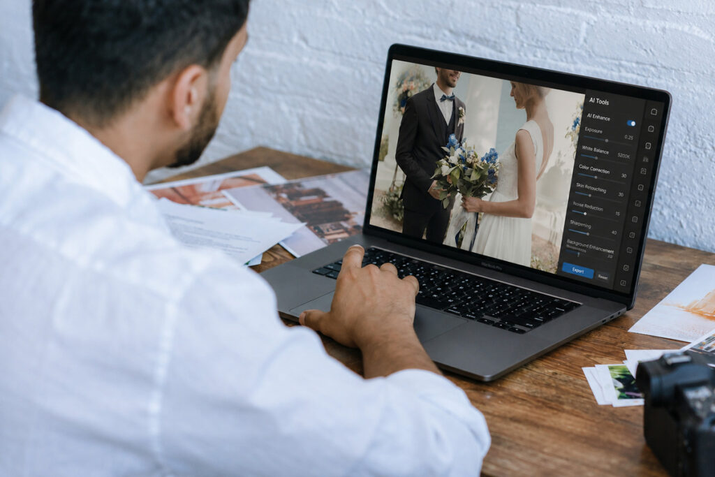 Photographer reviewing a wedding portrait using professional wedding photo editing services