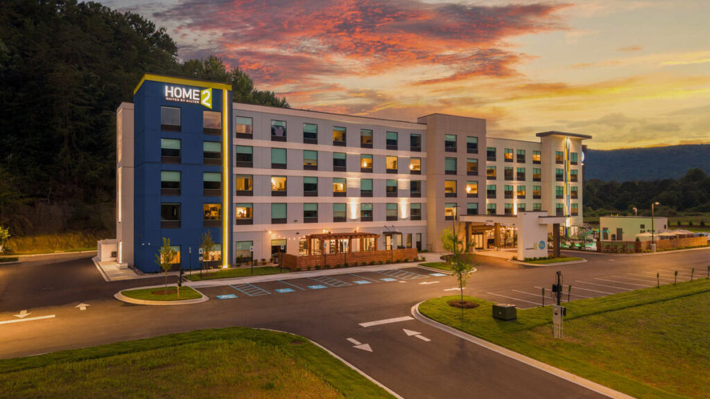 Hotel exterior transformed with AI real estate photo editor twilight conversion