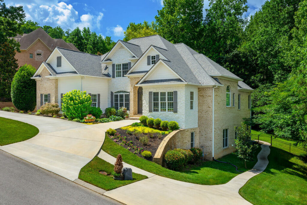 Architecture photography of a large residential home with landscaped grounds and driveway.