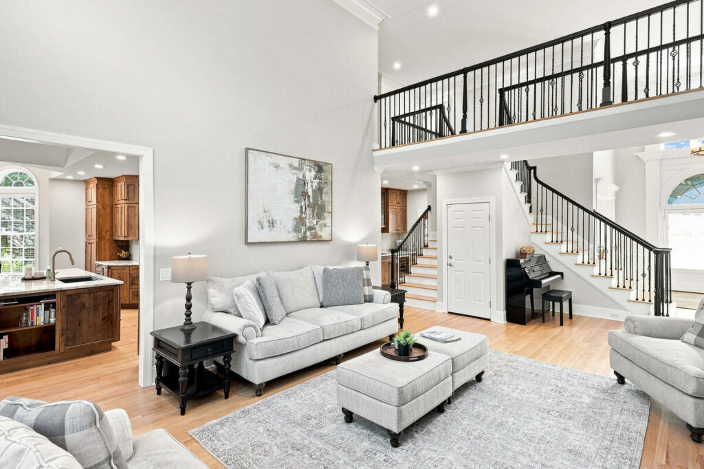 Architecture photography of a bright luxury living room with staircase and open interior design.