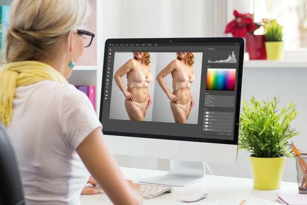 Commercial photographer editing and retouching a portrait on a desktop computer