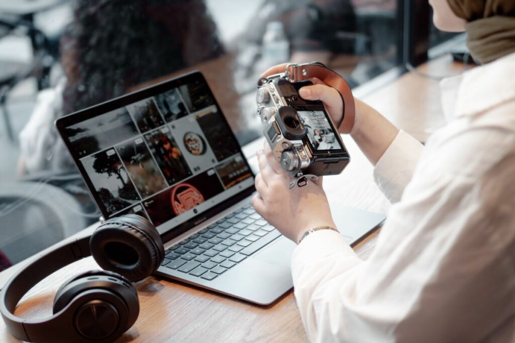 Commercial photographer reviewing images from a camera on a laptop