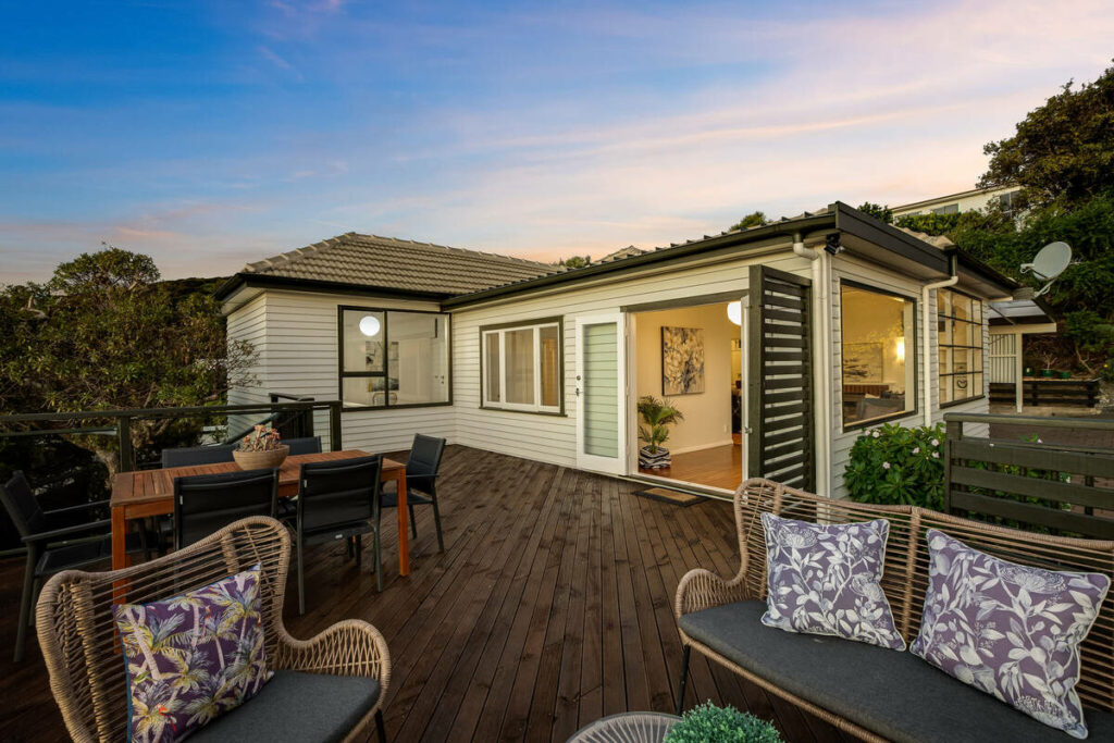 AutoHDR vs AI photo editing example showing an enhanced backyard exterior with a colorful twilight sky