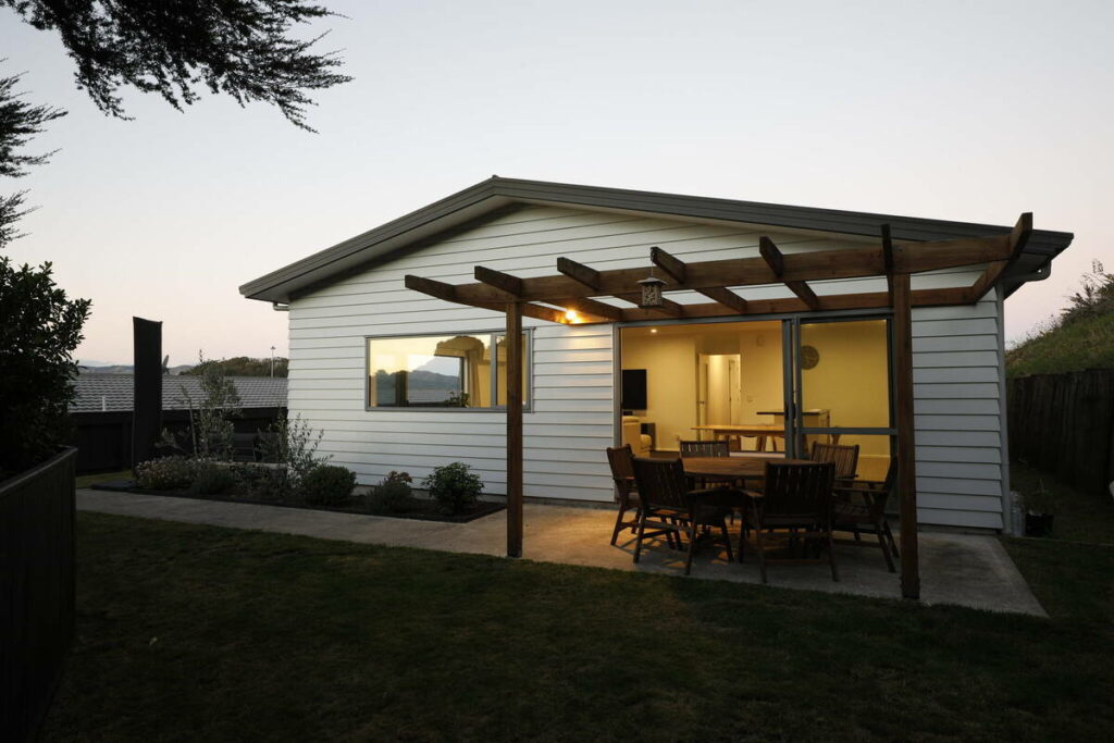 Before example for AutoHDR vs AI photo editing showing a darker backyard exterior at dusk