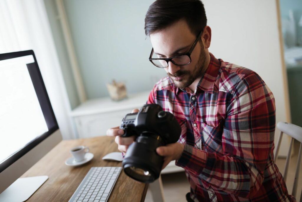 Photographer reviewing his camera during an editorial photo editing workflow