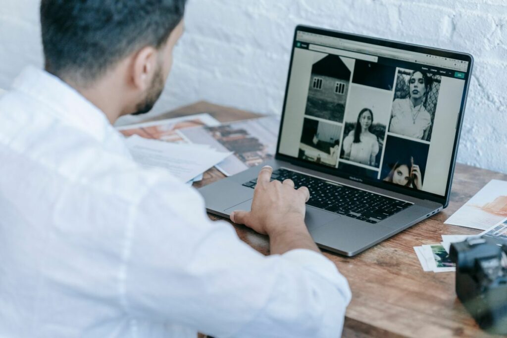 Photographer reviewing an editorial photo gallery on a laptop