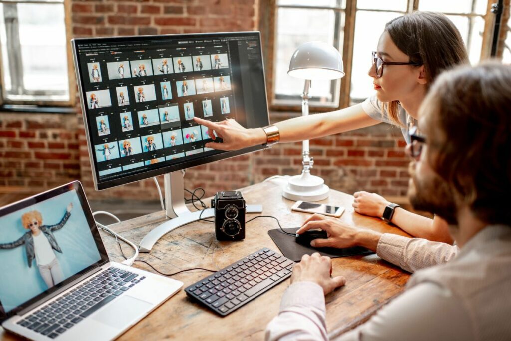 Photographers reviewing a gallery during an AI photo editing workflow