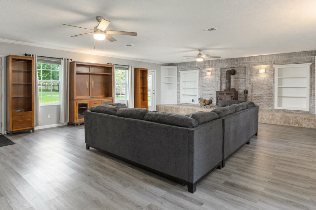 Lens distortion correction on a spacious family room with straight walls, shelving, and balanced perspective.