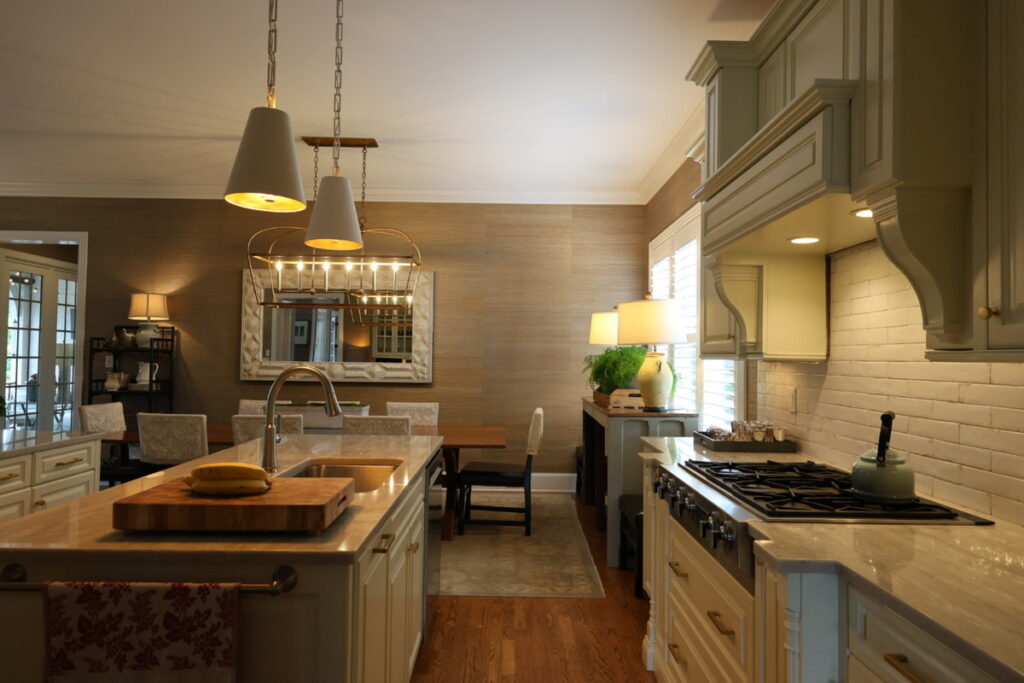 Kitchen interior before lens distortion correction with darker lighting and wide-angle perspective.