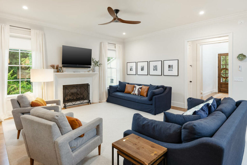 Lens distortion correction on a bright living room with straight walls, windows, and doorway lines.