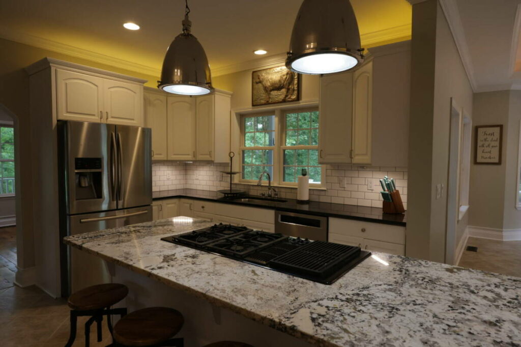 Kitchen before lens distortion correction with darker exposure and wide-angle interior perspective.