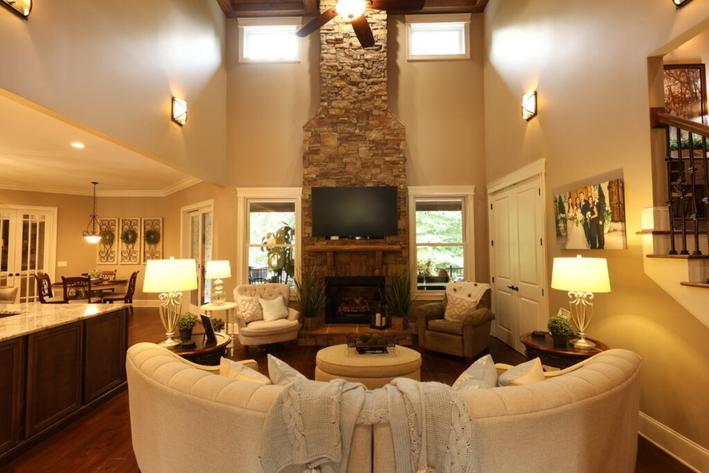 Vaulted living room before lens distortion correction with warm lighting and wide-angle perspective.