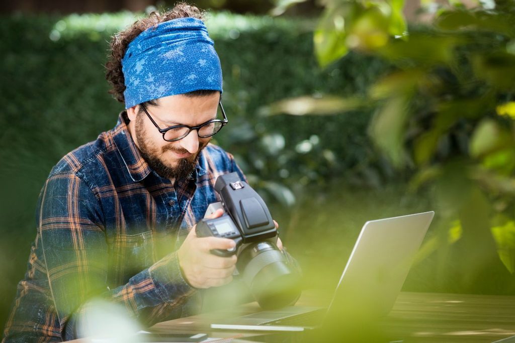 Photography coordinator managing photos and equipment while working on location
