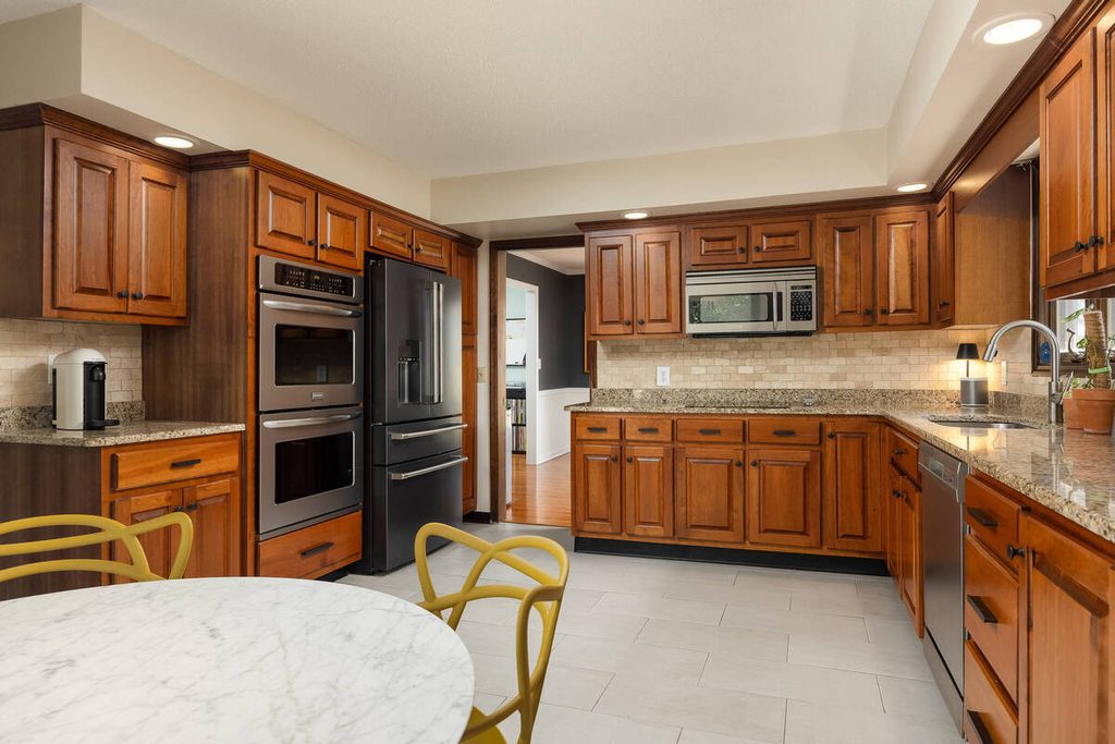 Real estate photo editing company enhanced kitchen photo with balanced lighting and natural colors.