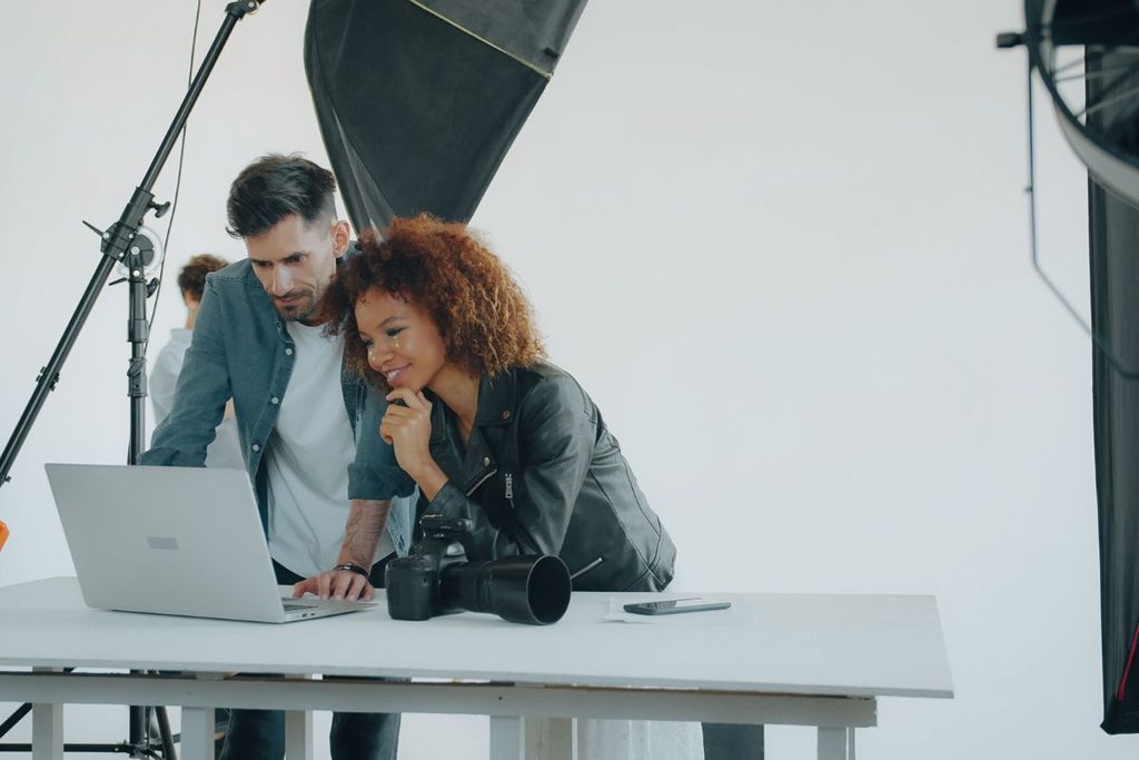 Photography team reviewing work together to help scale a photography business