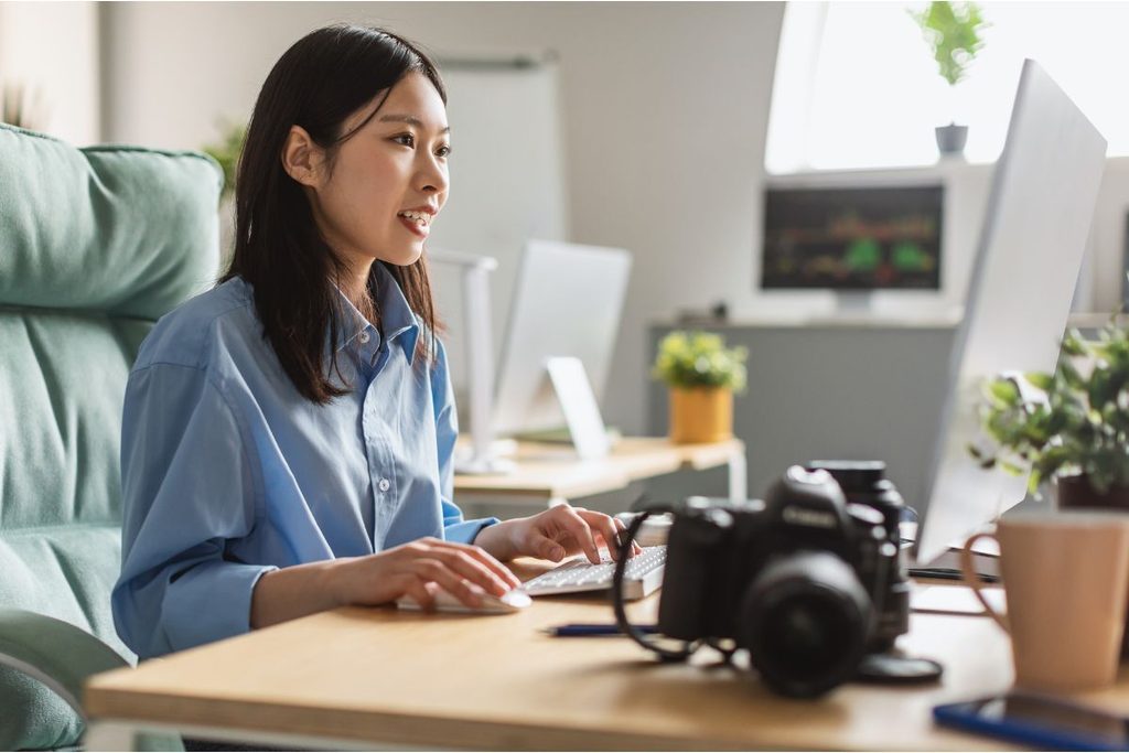 Photography business workflow management with a photographer working at a computer