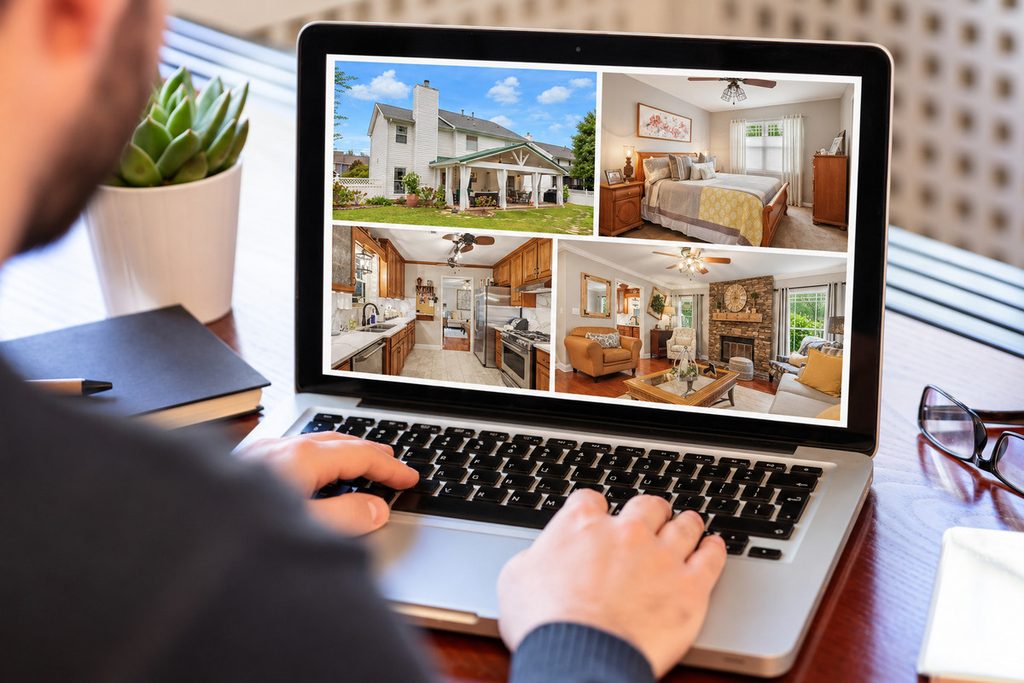Photographer reviewing a real estate photo gallery on a laptop after AI photo culling.
