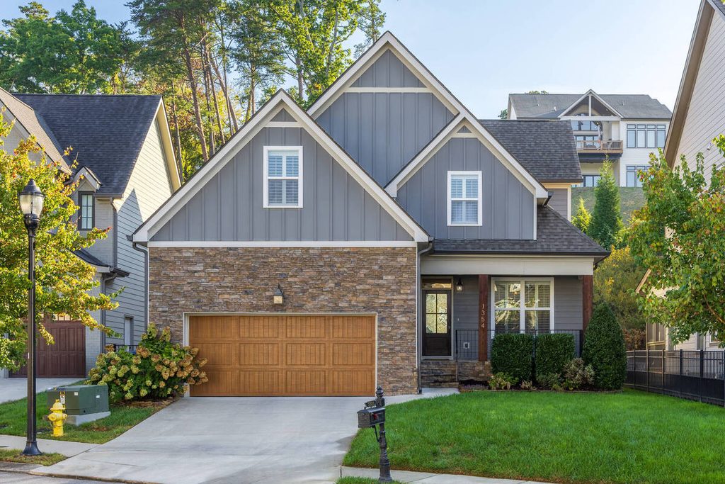 Two-story house exterior with stone siding and a garage for AI photo culling.