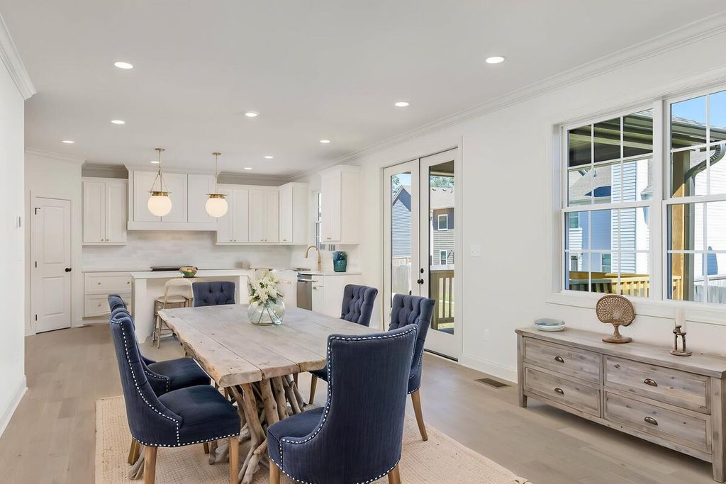 Virtual staging featuring a rustic dining table and navy blue chairs