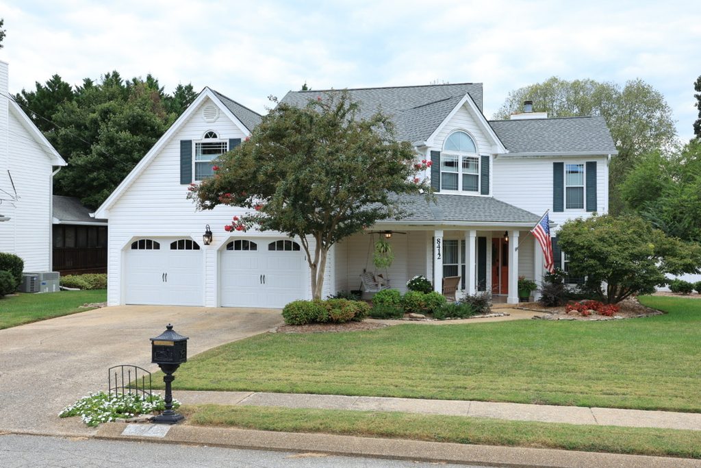 Original two-story white house exterior before AI sky replacement