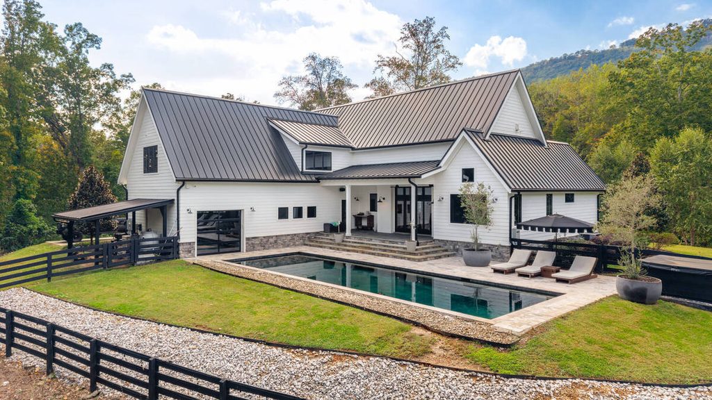 Luxury home with a swimming pool and enhanced sky using AI sky replacement