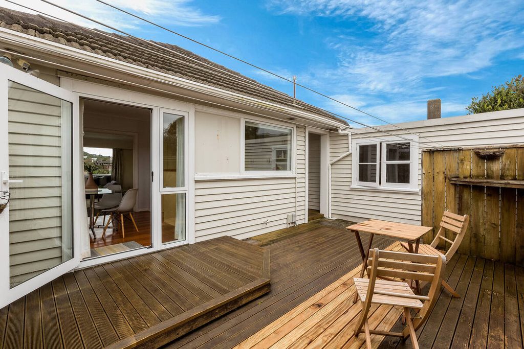 AI sky replacement adds a vibrant blue sky above a residential wooden deck