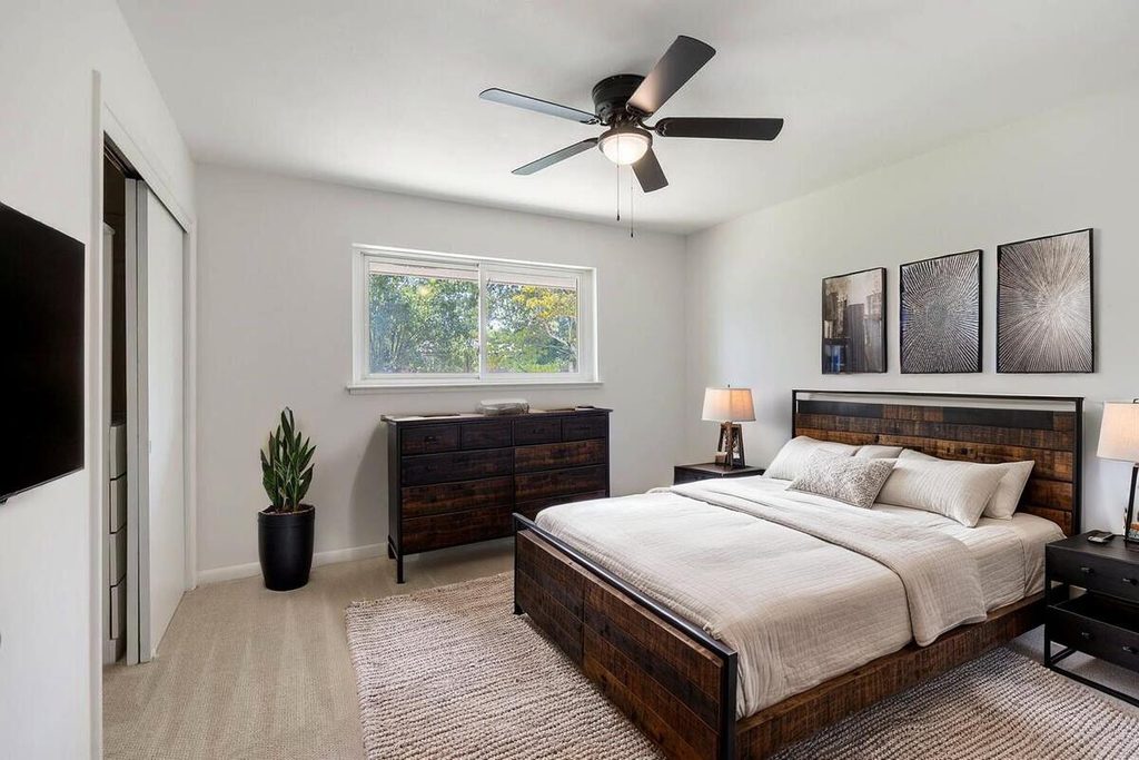Modern bedroom with dark wood furniture.