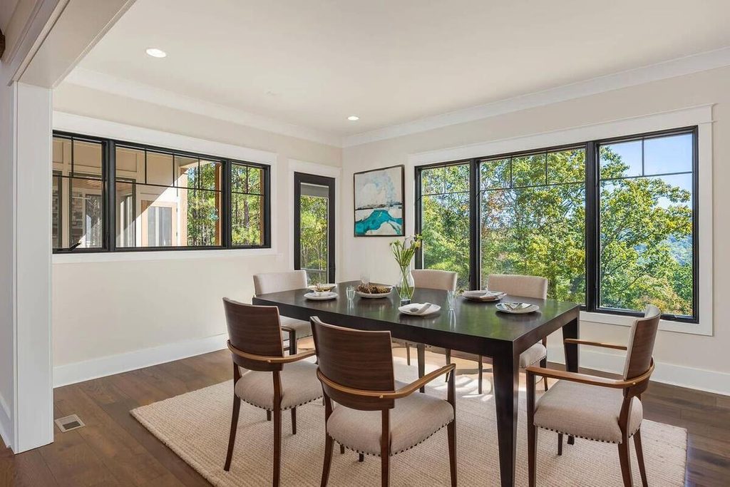 Staged dining room with wooden table.